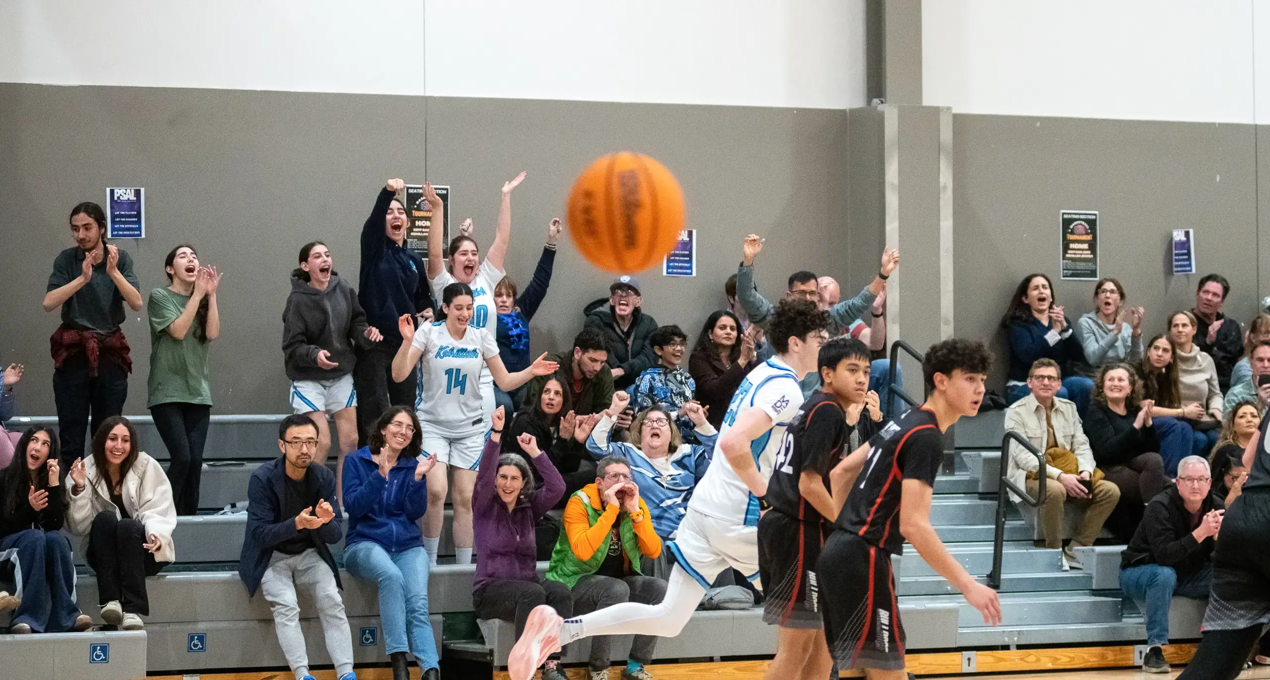 A lively basketball game in a gym featuring a group of players,  highlighting their energy and competitive spirit.