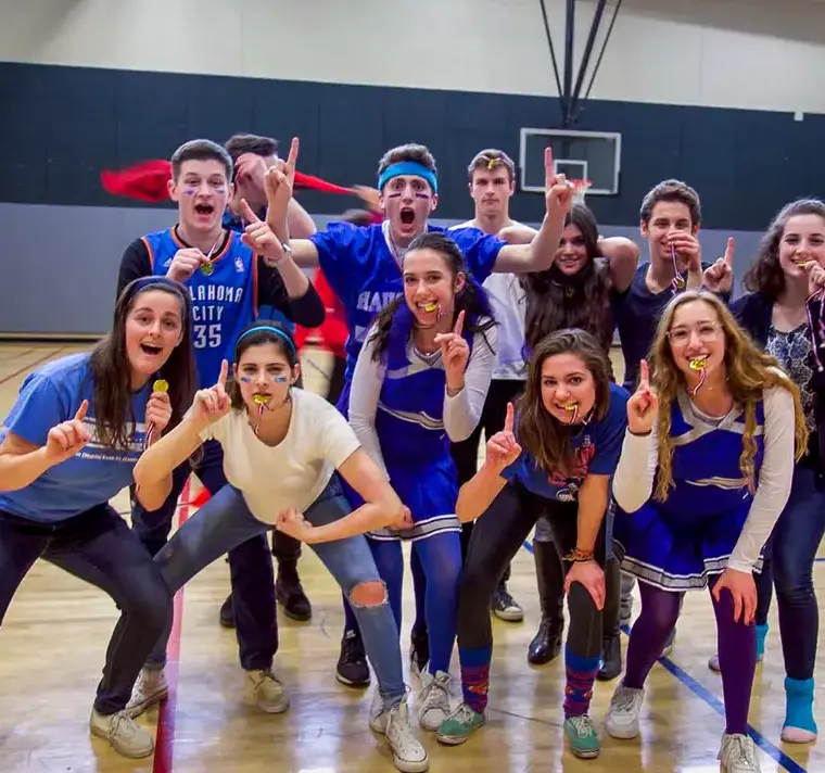 Students Posing and Smiling for Sports Game