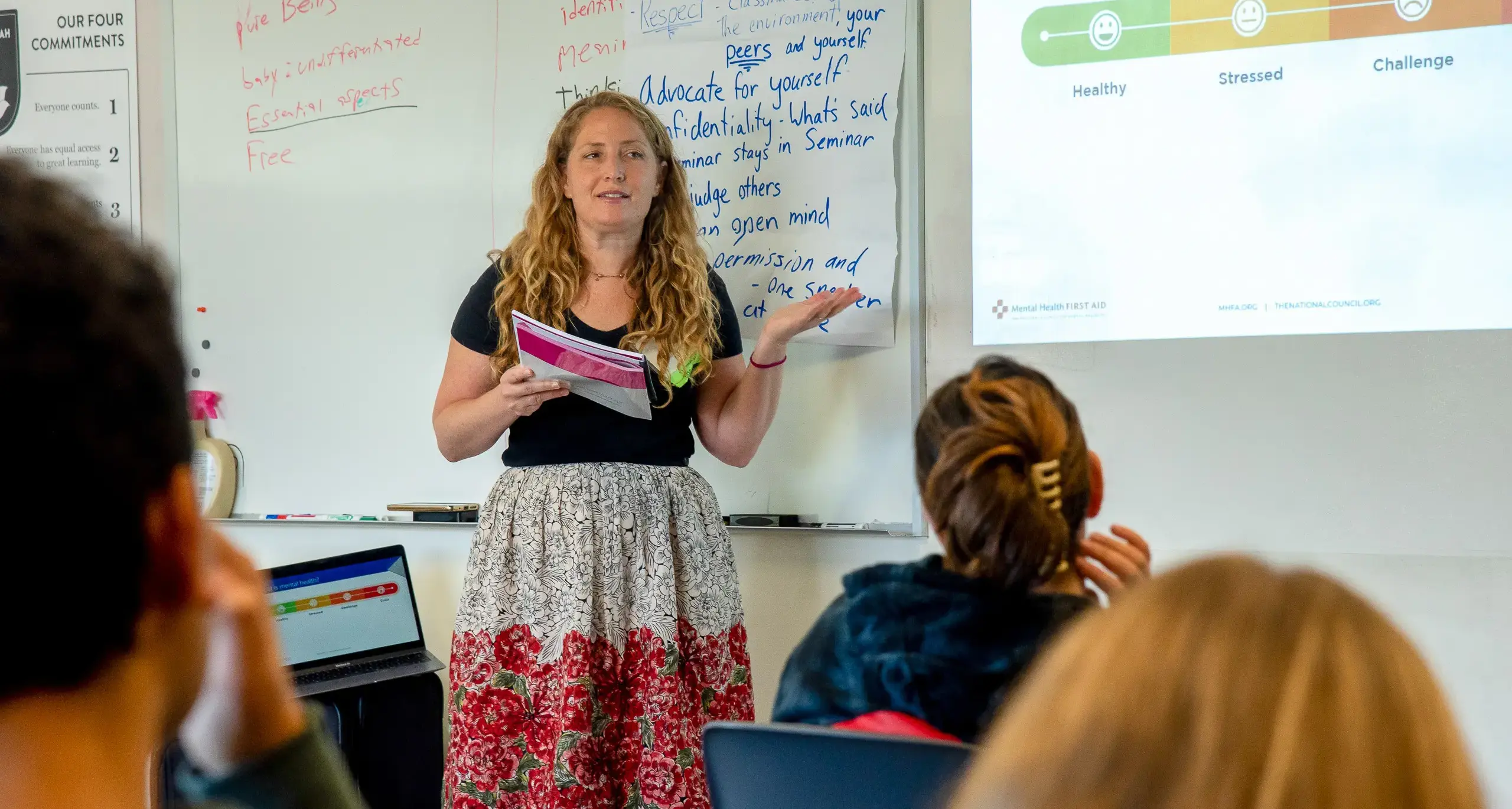 School Counselor Sarah Lesser talking to a classroom filled with  students about mental health.