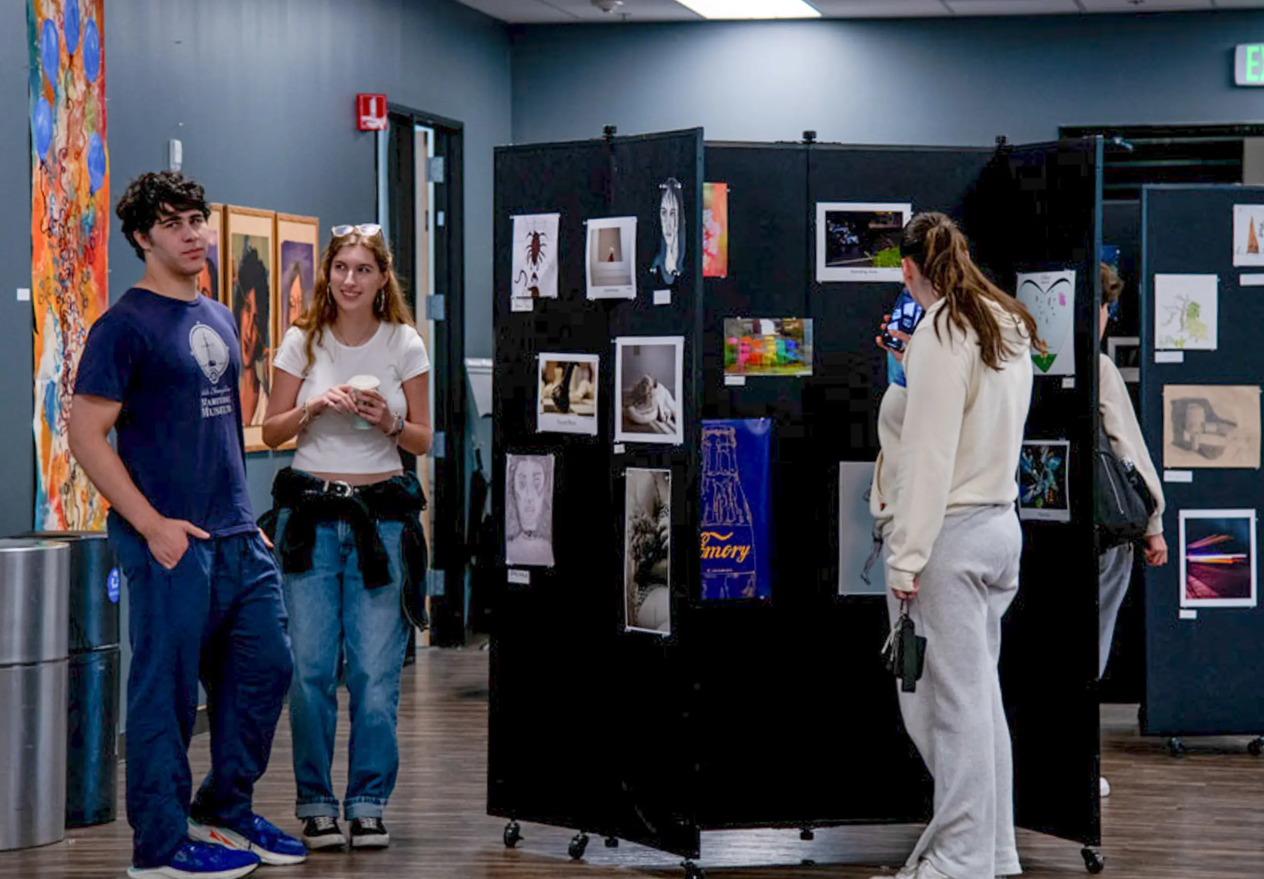 Sudents Viewing Artwork in Multi-Purpose Room
