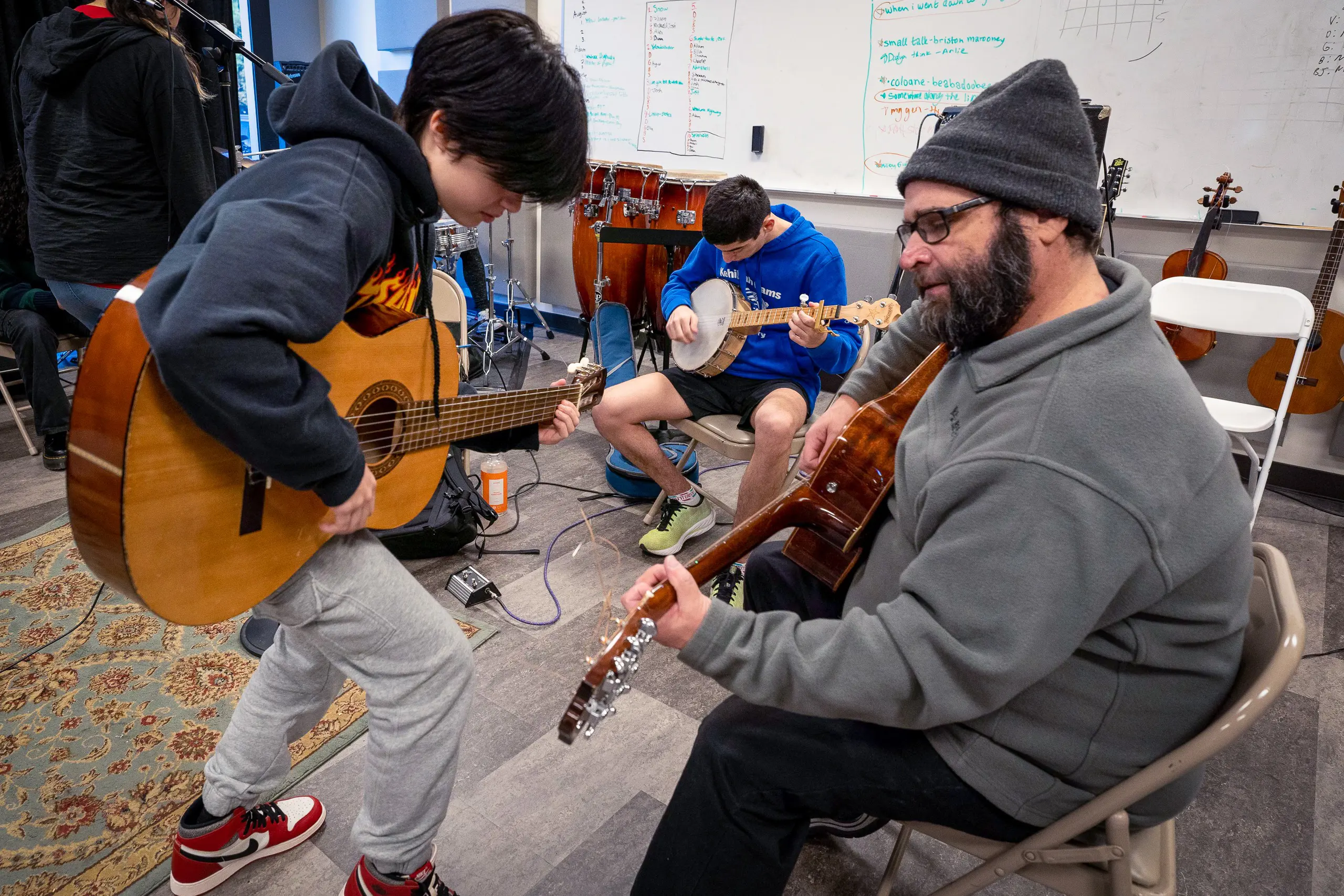 Student Playing Guitar with Teacher