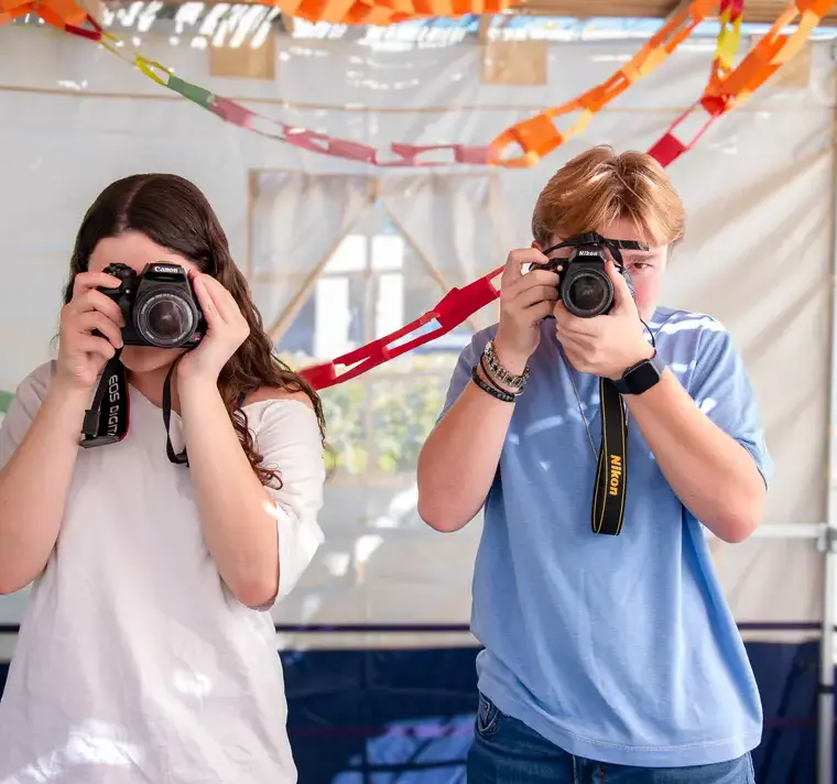 Students Talking Photos on Cameras Together